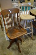 An oak swivel office chair and a bar stool.