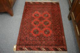 A small Persian bokhara type rug, 116cm x 79cm.
