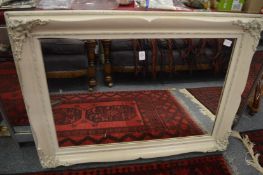 A rectangular mirror with white painted frame.