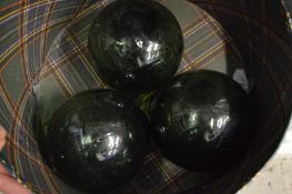 Three green glass fisherman's floats.