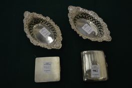 A silver cigarette case, a silver compact and a pair of silver bonbon dishes.