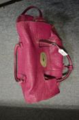 A Mulberry purple coloured leather handbag and two other bags.