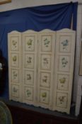 A floral decorated cream ground four section folding dressing screen.
