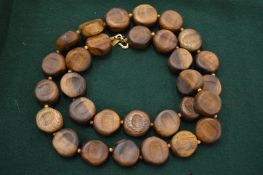 A Kenneth Lane wooden necklace.