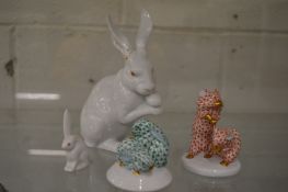 A Herend white glazed rabbit, 15.5cm high, ears damaged together with a small white glazed rabbit