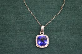 Decorative silver pendant and chain.