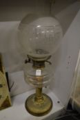 A cut glass and brass oil lamp.
