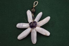 A large flower shaped pendant.