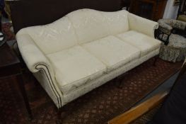 A Georgian style cream damask upholstered three seater settee.