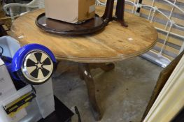 A pine circular pedestal dining table.