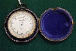 A leather cased pocket barometer by Dollond of London.