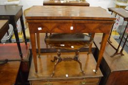 A mahogany rectangular fold-over card table.