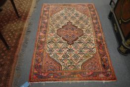 A Persian design rug, cream ground with stylised decoration, 164cm x 108cm.