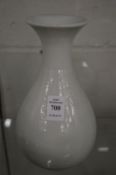 A Chinese blanc de chine bottle vase with moulded dragon decoration.