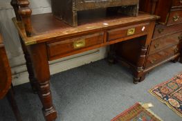 A 19th century walnut two drawer writing table.