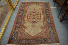 Persian rug, cream ground with a central panel depicting birds, 199cm x 132cm.