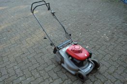 A Honda petrol rotary lawn mower.
