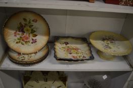 A Carltonware floral decorated part dessert service comprising three plates and two square dishes