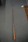 A long copper hunting horn.