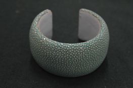 A faux shagreen bangle, signed Cookcoo Moment.