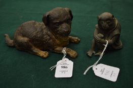 Cold painted bronze model of a seated dog together with a cast metal model of a monkey.