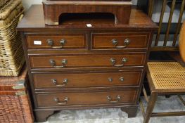 A reproduction mahogany chest of drawers.