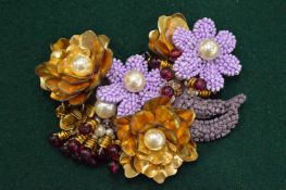 A decorative large flower form brooch.