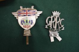 A B.R.D.C enamel and plated car badge and another badge.