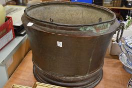 A large copper log bin.