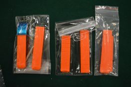 Orange wristwatch straps.