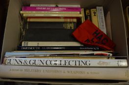 Box of books relating to guns and military topics.