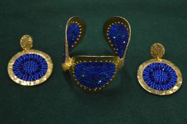 Decorative bangle with matching pair of earrings.