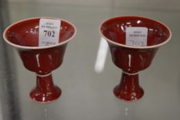 A pair of small sang de boeuf stem cups.