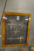 A group of five small bronze crucifixes, framed and glazed.
