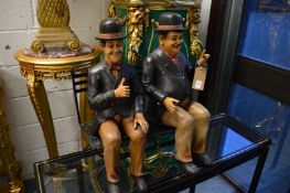 Fibreglass models of Laurel and Hardy on a wrought iron bench.
