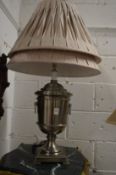 An urn shaped table lamp with pleated shade and spare shade.