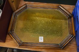 A wooden framed brass tray.