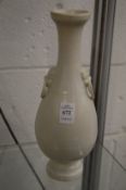 A blanc de chine bottle vase with ring handles.