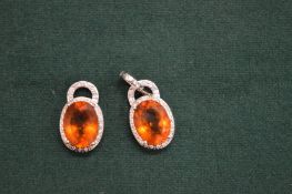 A pair of decorative silver earrings.