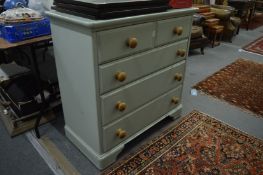 A green painted pine chest of drawers.