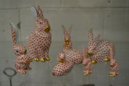A group of Herend rabbits, all in red fishnet pattern, largest 14cm high.