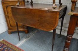 A George III mahogany and rosewood banded Pembroke table.