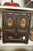 A Japanese black lacquer and gilt decorated table cabinet.