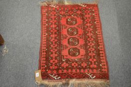 A small Persian bokhara type rug, 77cm x 52cm.