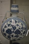 A Chinese blue and white moon flask painted with flowers.