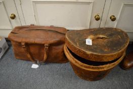 A leather cased top hat, internal size 19cm x 15cm together with a leather bag.