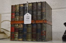 A Huntley & Palmers biscuit tin in the form of a group of books held together with by a leather