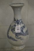 A Chinese blue and white bottle vase decorated with a dragon.