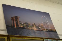 A large city scape at night time, photographic print together with another.