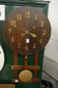 An Arts and Crafts style oak wall clock.
